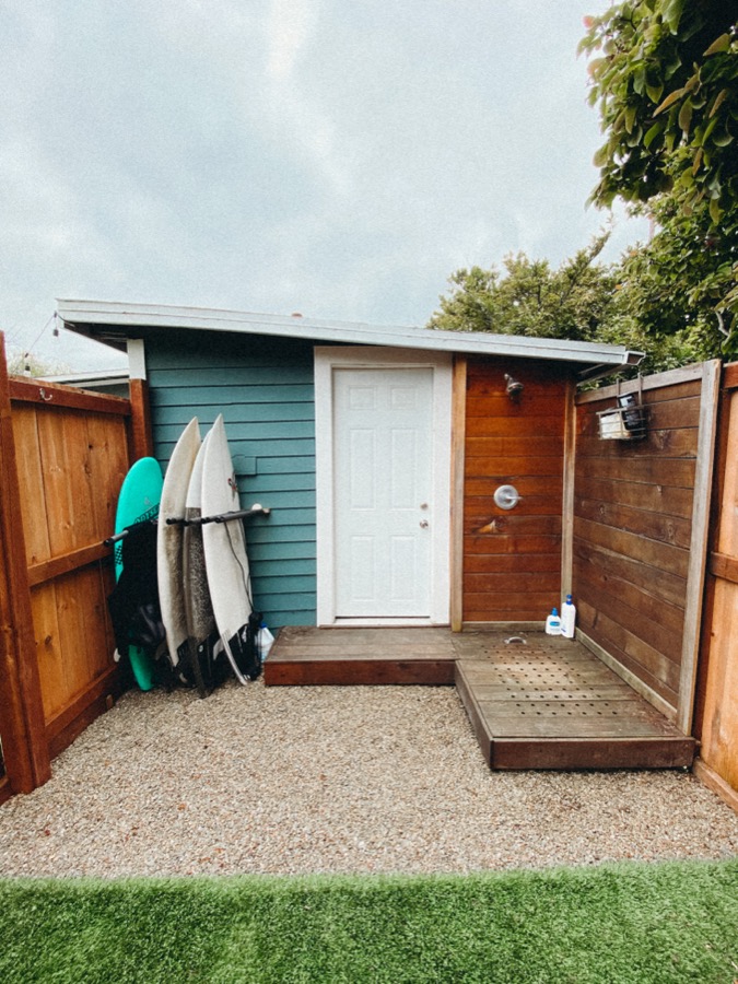 The backyard surf shack, boards racked by the outdoor shower